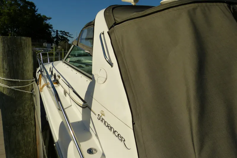 Slide: The Image of 1995 Sea Ray Sundancer 370 docked, featuring sleek design and covered seating area. - 50