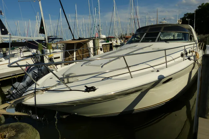 Slide: The Image of 1995 Sea Ray Sundancer 370 docked at marina, surrounded by sailboats. - 52