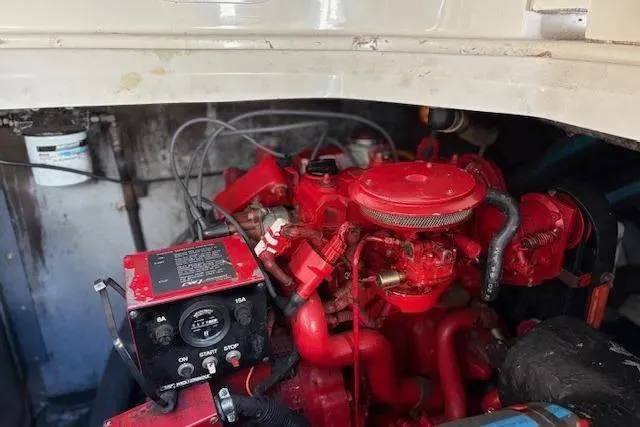 Slide: The Image of Engine compartment of a 1995 Sea Ray Sundancer 370 with a red engine and control panel. - 55