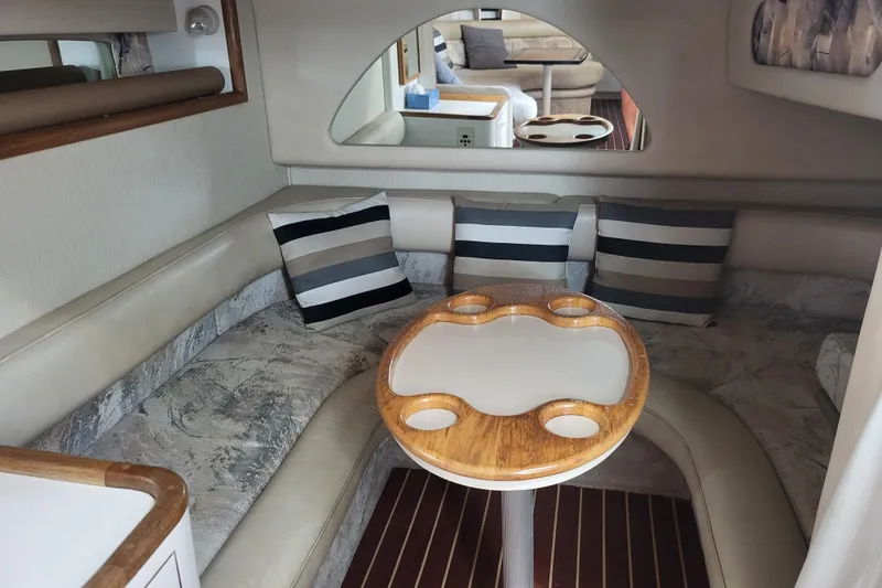 Slide: The Image of Interior of 1995 Sea Ray Sundancer 370 with cozy seating and striped cushions. - 8