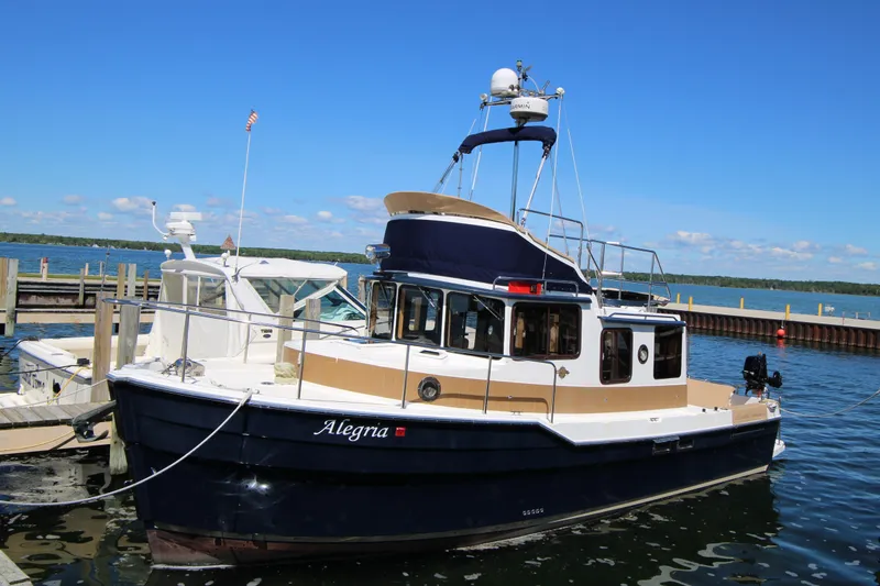 The Image of 2013 Ranger Tugs R-31 CB boat docked on a sunny day. - 1