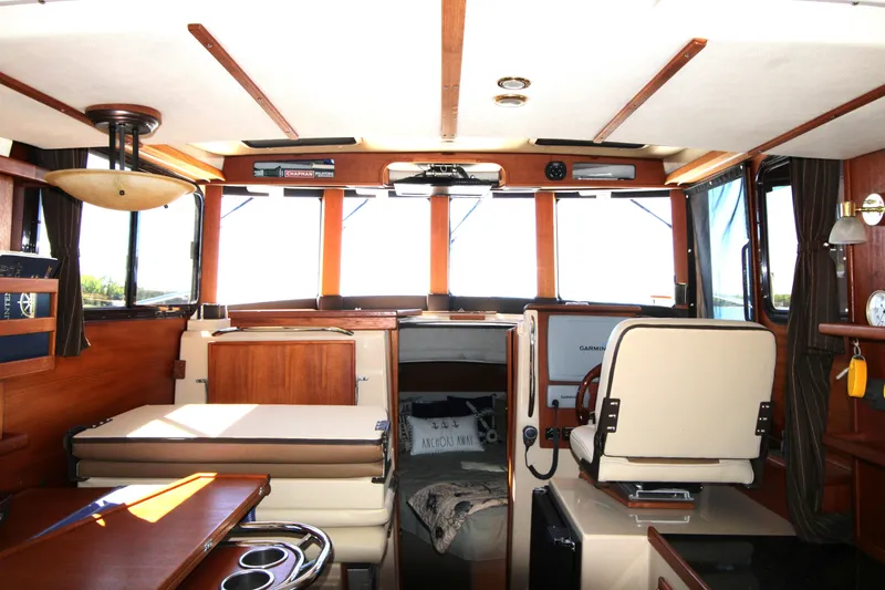 Slide: The Image of Interior of 2013 Ranger Tugs R-31 CB boat with helm, seating, and wooden accents. - 10