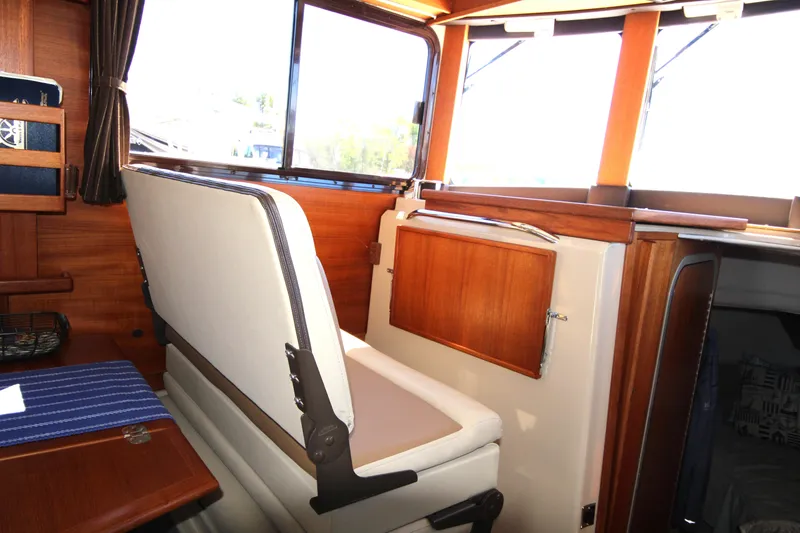 Slide: The Image of Interior of 2013 Ranger Tugs R-31 CB with wooden accents and seating. - 20