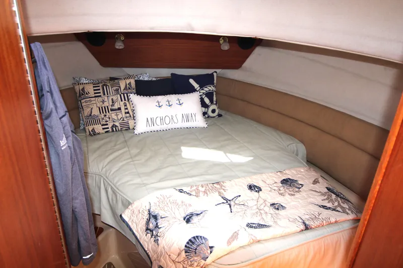 Slide: The Image of Cozy cabin interior of 2013 Ranger Tugs R-31 CB with nautical-themed bedding. - 22