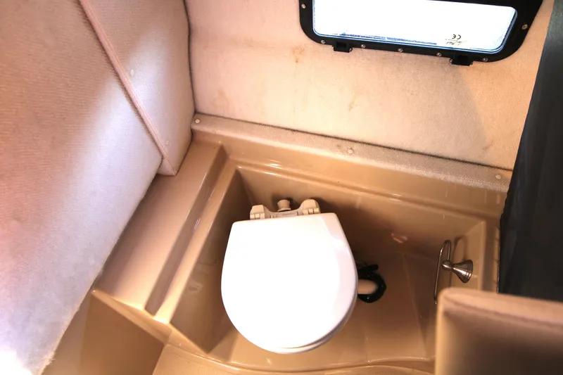 Slide: The Image of 2013 Ranger Tugs R-31 CB boat bathroom with compact toilet and window. - 29