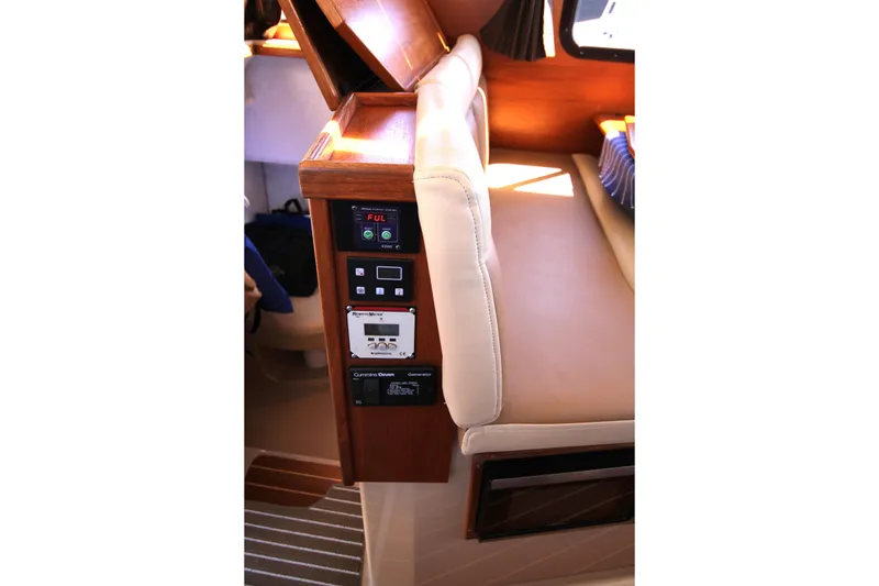 Slide: The Image of Interior view of a 2013 Ranger Tugs R-31 CB boat, featuring control panels and seating. - 31