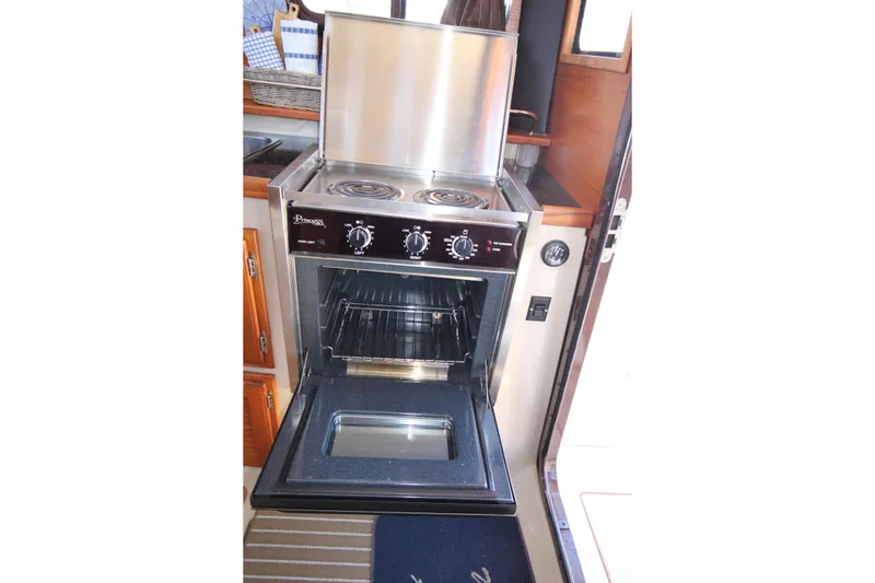 Slide: The Image of Stove and oven inside a 2013 Ranger Tugs R-31 CB boat galley. - 32