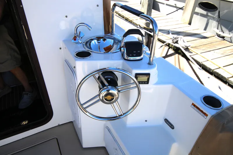 Slide: The Image of 2013 Ranger Tugs R-31 CB helm station with steering wheel and controls. - 33