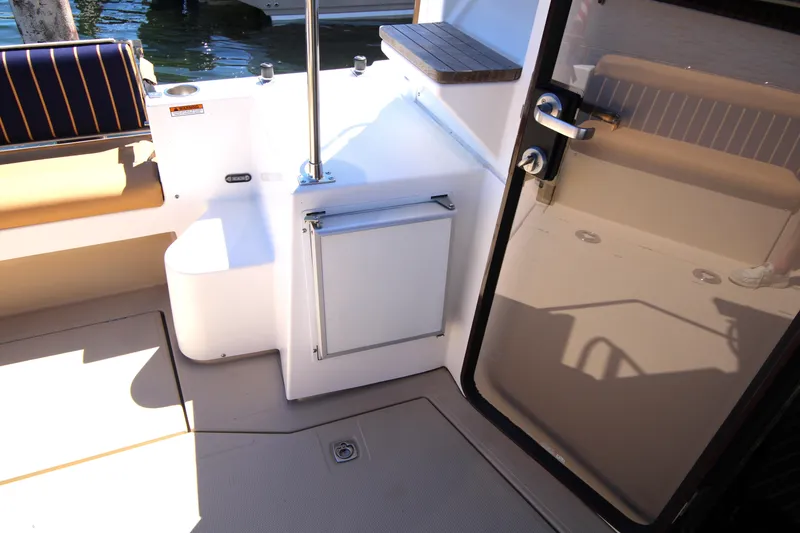 Slide: The Image of Interior view of 2013 Ranger Tugs R-31 CB boat, featuring seating and door details. - 34