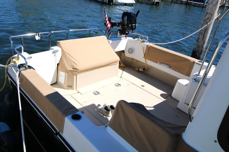 Slide: The Image of 2013 Ranger Tugs R-31 CB boat deck with seating, moored by the water. - 4