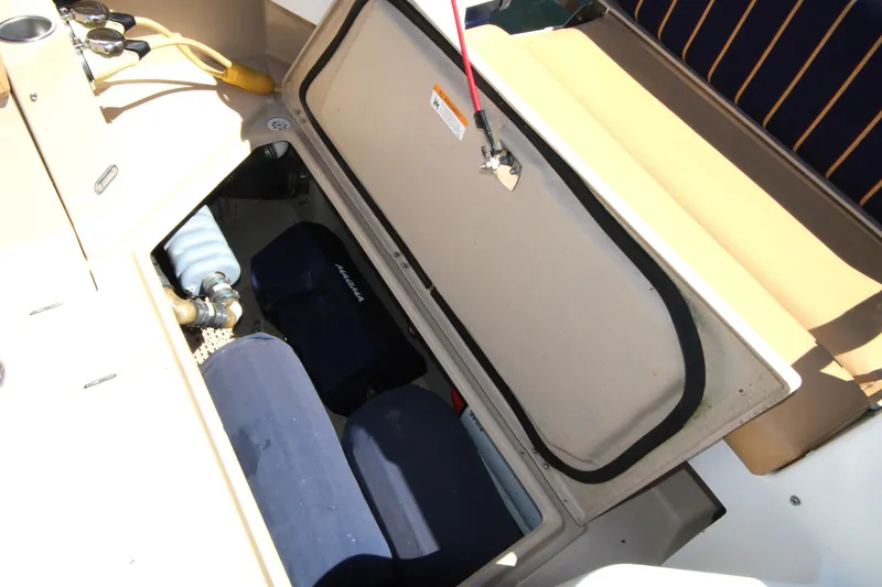 Slide: The Image of Open storage compartment on 2013 Ranger Tugs R-31 CB boat, showing interior equipment. - 46