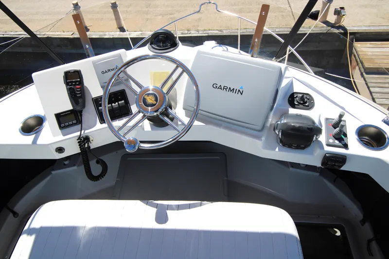 Slide: The Image of Helm of 2013 Ranger Tugs R-31 CB with Garmin navigation system and steering wheel. - 48