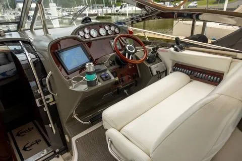 Slide: The Image of 2008 Regal Commodore 3860 helm with gauges, steering wheel, and navigation equipment. - 2