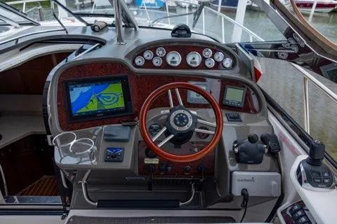 Slide: The Image of 2008 Regal Commodore 3860 boat dashboard with navigation screens and controls. - 4