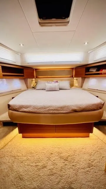Slide: The Image of Luxurious bedroom interior of 2022 Greenline 48 Flybridge yacht with ambient lighting. - 14