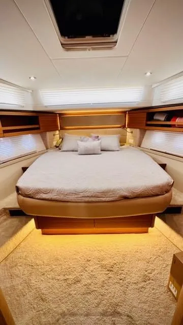Slide: The Image of Luxurious bedroom interior of 2022 Greenline 48 Flybridge yacht with elegant lighting and cozy bedding. - 15