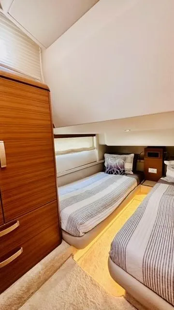 Slide: The Image of Luxurious twin cabin in 2022 Greenline 48 Flybridge yacht, featuring modern design and cozy bedding. - 18