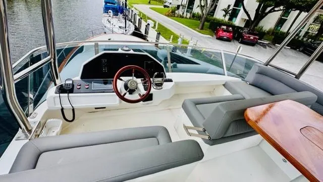 Slide: The Image of Flybridge of 2022 Greenline 48 with Hardtop, featuring modern helm and seating area. - 25