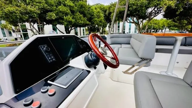 Slide: The Image of 2022 Greenline 48 Flybridge with Hardtop, featuring modern helm and seating area. - 26