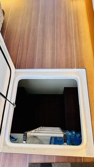 Slide: The Image of Hatch opening on 2022 Greenline 48 Flybridge with Hardtop, revealing storage area. - 32