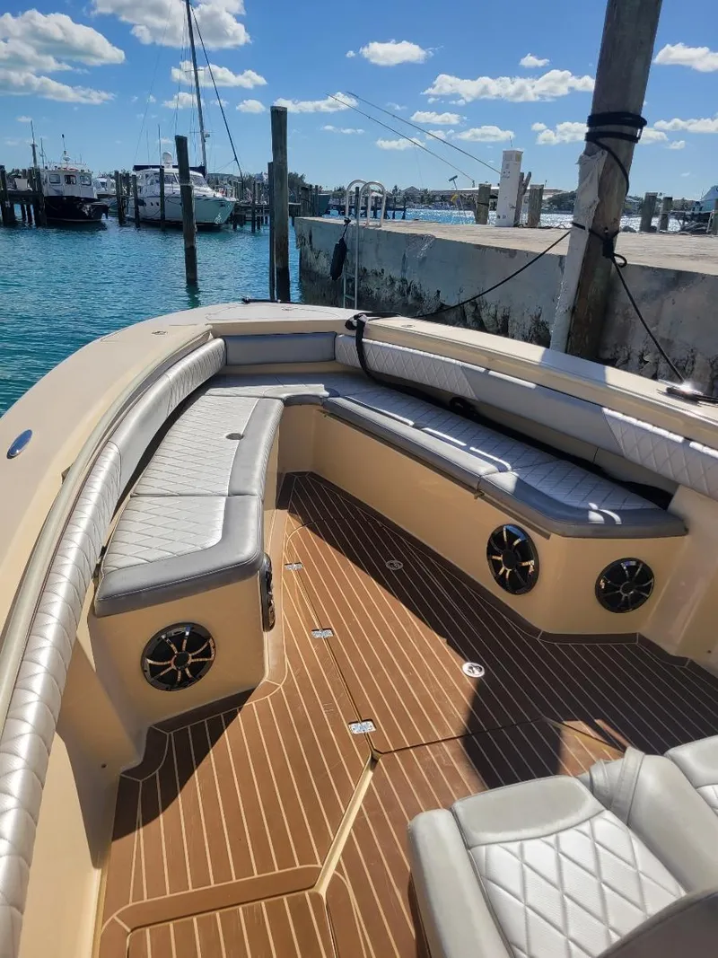 Slide: The Image of 2013 Statement 38 SUV Open boat with spacious seating docked at a marina. - 2
