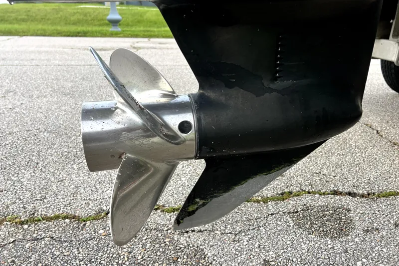 Slide: The Image of Propeller of a 1998 Boston Whaler 230 Outrage on pavement background. - 12