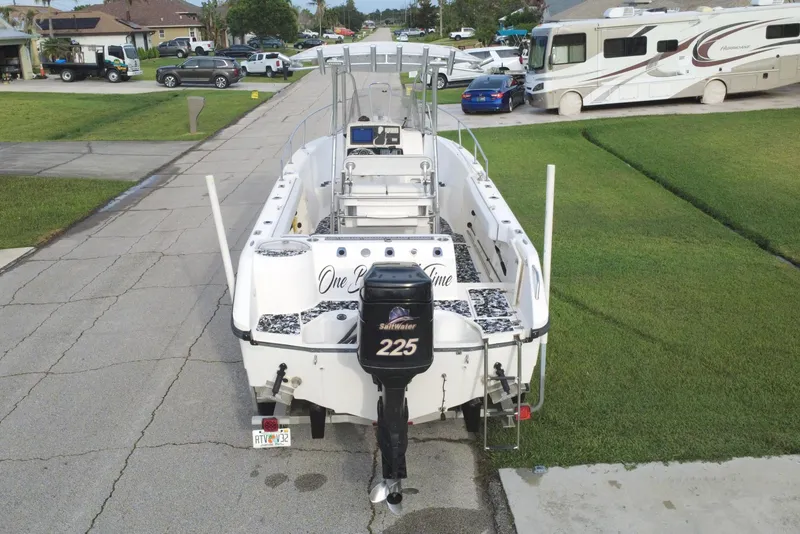 Slide: The Image of 1998 Boston Whaler 230 Outrage boat parked on a residential street. - 14