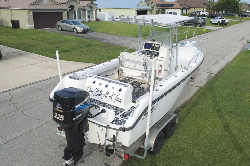 Slide: The Image of 1998 Boston Whaler 230 Outrage boat on trailer in suburban neighborhood. - 15