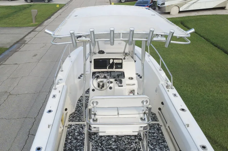 Slide: The Image of 1998 Boston Whaler 230 Outrage boat with center console and T-top on a residential street. - 20
