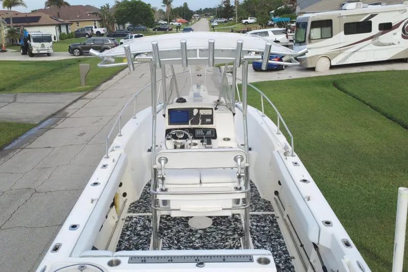 Slide: The Image of 1998 Boston Whaler 230 Outrage boat parked in a residential driveway. - 23