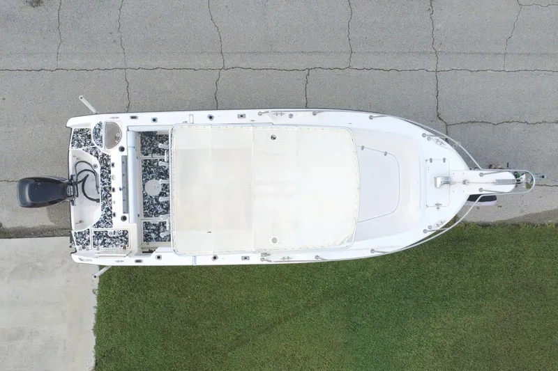 Slide: The Image of Overhead view of a 1998 Boston Whaler 230 Outrage boat on pavement and grass. - 24