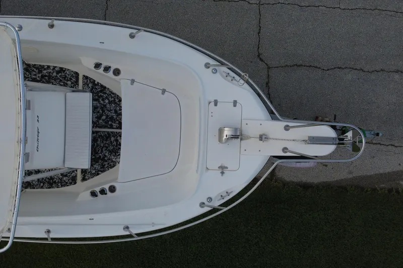 Slide: The Image of Top view of a 1998 Boston Whaler 230 Outrage boat on pavement. - 27