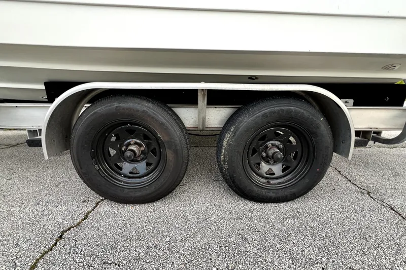 Slide: The Image of Trailer wheels of a 1998 Boston Whaler 230 Outrage on pavement. - 29