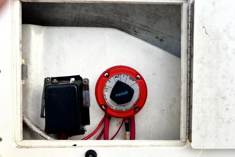 Slide: The Image of Battery switch and wiring inside a 1998 Boston Whaler 230 Outrage boat compartment. - 34