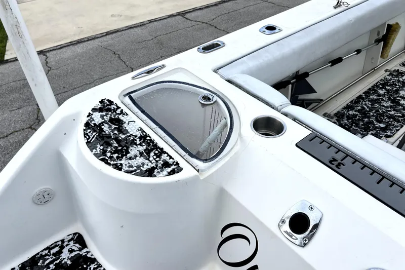 Slide: The Image of 1998 Boston Whaler 230 Outrage boat deck with storage compartment and seating. - 36