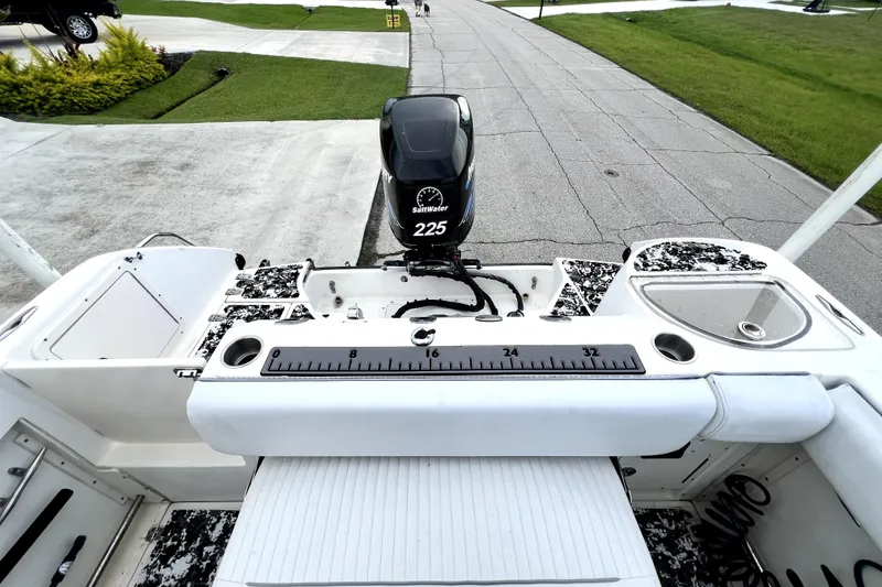 Slide: The Image of 1998 Boston Whaler 230 Outrage boat with Saltwater 225 engine, docked on pavement. - 38