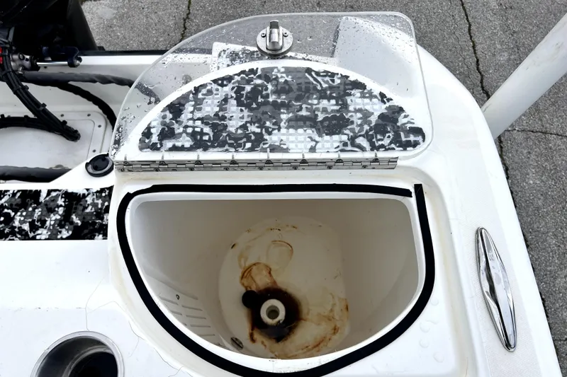 Slide: The Image of Open storage compartment on a 1998 Boston Whaler 230 Outrage boat, showing interior details. - 39