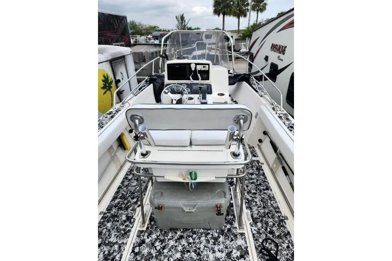 Slide: The Image of 1998 Boston Whaler 230 Outrage boat interior with steering console and seating. - 4