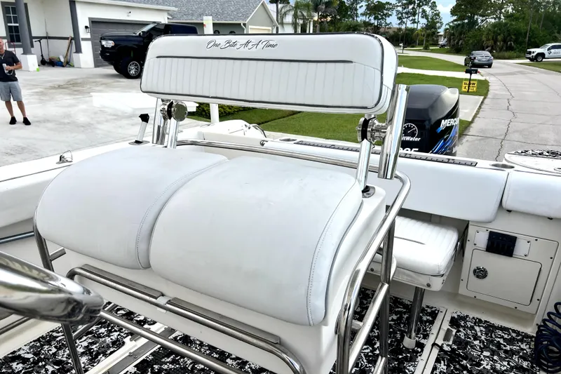 Slide: The Image of 1998 Boston Whaler 230 Outrage boat interior with white seating and chrome details. - 41