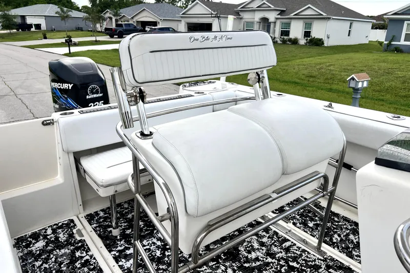 Slide: The Image of 1998 Boston Whaler 230 Outrage boat interior with Mercury engine and cushioned seating. - 42