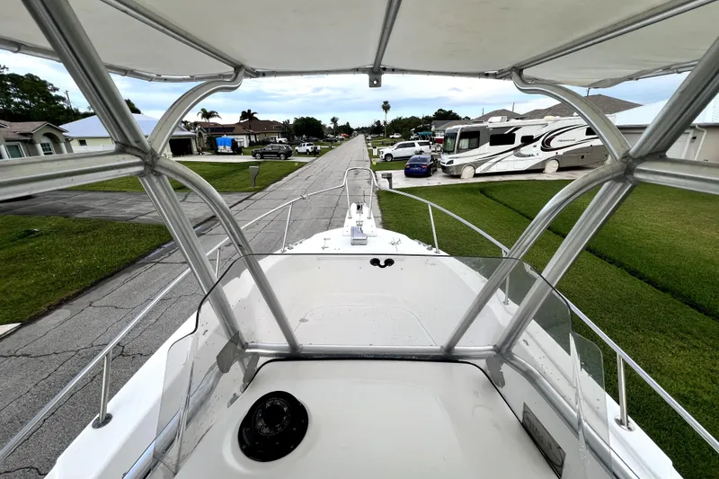 Slide: The Image of 1998 Boston Whaler 230 Outrage boat on a residential street, view from helm. - 43