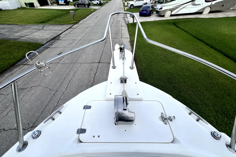 Slide: The Image of Bow view of a 1998 Boston Whaler 230 Outrage boat on a residential street. - 46