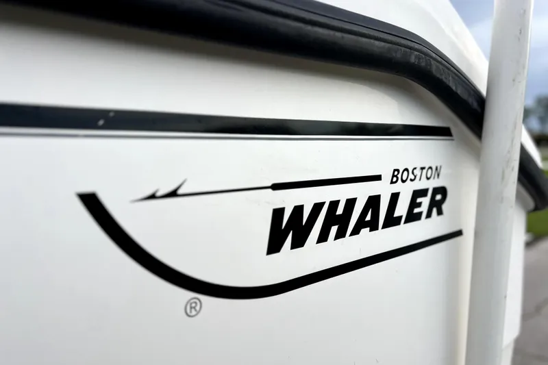 Slide: The Image of Close-up of 1998 Boston Whaler 230 Outrage logo on boat hull. - 48