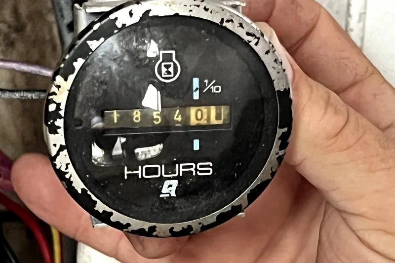 Slide: The Image of Hour meter showing 1854 hours on a 1998 Boston Whaler 230 Outrage boat. - 51