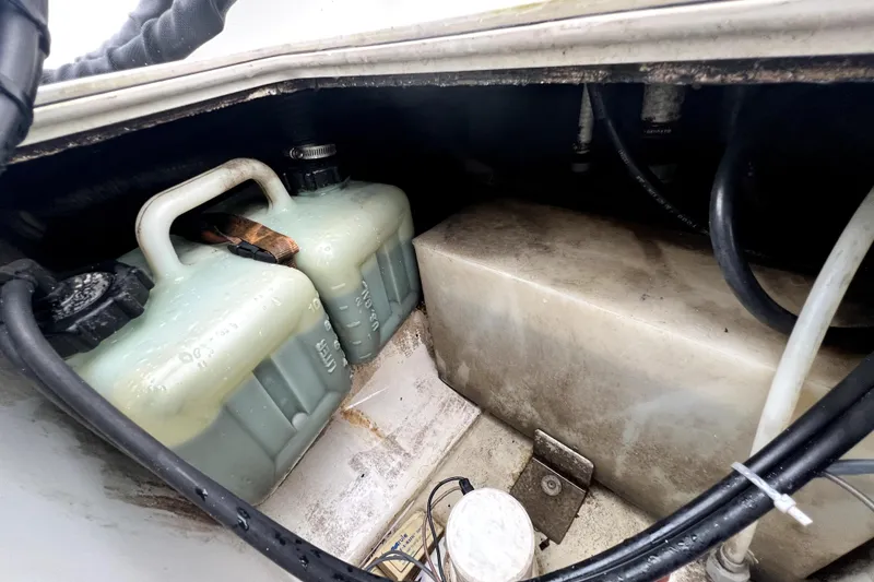 Slide: The Image of Storage compartment of a 1998 Boston Whaler 230 Outrage boat with fuel containers. - 54
