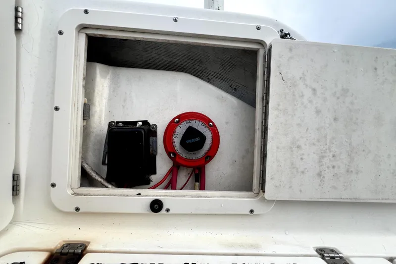 Slide: The Image of Battery compartment of a 1998 Boston Whaler 230 Outrage boat with red switch. - 56