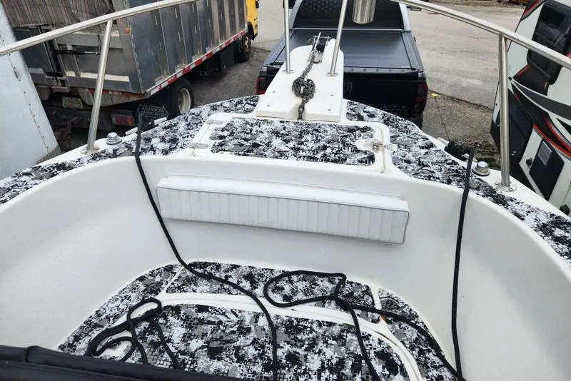 Slide: The Image of 1998 Boston Whaler 230 Outrage boat deck with patterned flooring and railing. - 6