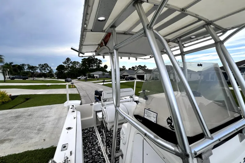 Slide: The Image of 1998 Boston Whaler 230 Outrage boat with T-top, parked in a residential neighborhood. - 63