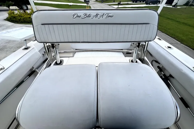 Slide: The Image of Boston Whaler 230 Outrage 1998 boat seating with "One Bite At A Time" text. - 65