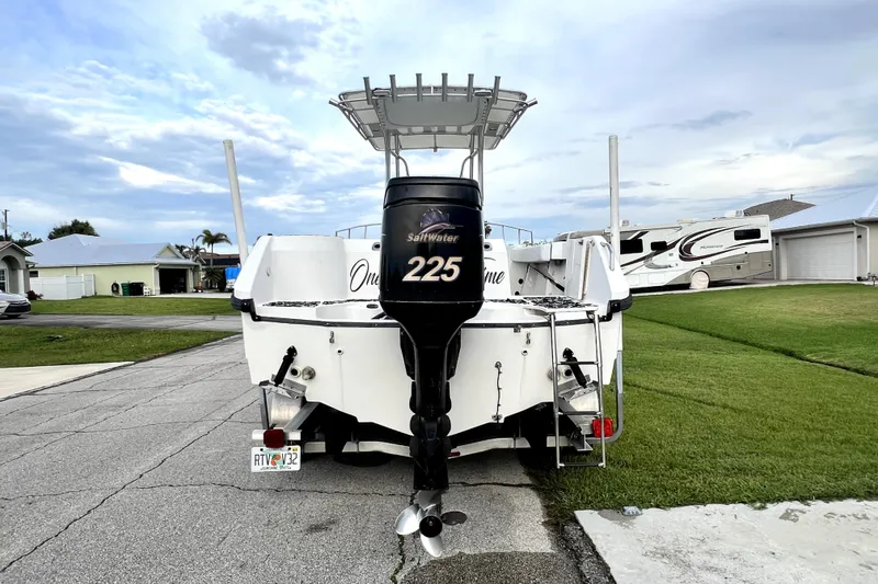 Slide: The Image of 1998 Boston Whaler 230 Outrage boat with 225 Saltwater engine, parked in residential area. - 7
